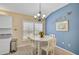 Charming breakfast nook with white table and blue accent wall at 7157 Del Lago Dr, Sarasota, FL 34238