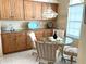 Bright breakfast nook with wood cabinets and glass-top table at 5717 Cottonwood St, Bradenton, FL 34203