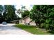 Tan house exterior with carport and landscaping at 1820 7Th E Ave, Bradenton, FL 34208