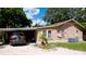 Tan house exterior with carport and landscaping at 1820 7Th E Ave, Bradenton, FL 34208