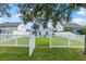 Large backyard with white fence and access gate at 4218 Day Bridge Pl, Ellenton, FL 34222