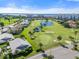 Aerial view of community with golf course, water, and luxury homes at 1602 Fairway Trce # 1602, Palmetto, FL 34221