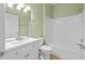 Clean bathroom with white vanity, tub, and light green walls at 1717 Bonita Bluff Ct, Ruskin, FL 33570