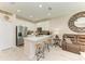 Modern kitchen with white cabinets, stainless steel appliances, and an island with seating at 10924 Brightleaf Ct, Riverview, FL 33569