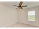 Well-lit bedroom featuring a ceiling fan and a large window at 10924 Brightleaf Ct, Riverview, FL 33569