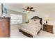 Elegant bedroom with a large bed, ceiling fan, and window at 10924 Brightleaf Ct, Riverview, FL 33569