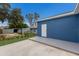 Large backyard with a concrete patio and detached shed at 1001 2Nd W St, Bradenton, FL 34205