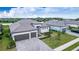 Two-story house with tile roof, three car garage, and landscaped front yard at 15909 Tradewind Ter, Lakewood Ranch, FL 34211