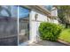Back patio with sliding glass doors and lush landscaping at 3309 Highlands Bridge Rd # 58, Sarasota, FL 34235