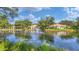 Scenic community lake with a fountain and surrounding homes at 3309 Highlands Bridge Rd # 58, Sarasota, FL 34235