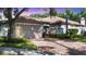 Home exterior with a two-car garage and landscaped front yard at 3309 Highlands Bridge Rd # 58, Sarasota, FL 34235