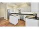 White kitchen with granite countertops and island at 3309 Highlands Bridge Rd # 58, Sarasota, FL 34235