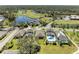 Aerial view of a house with a pool, situated in a golf course community at 4519 Bent Tree Blvd, Sarasota, FL 34241