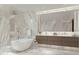 Luxurious bathroom with soaking tub, double vanity, and marble finishes at 668 Quay Commons # 1604, Sarasota, FL 34236