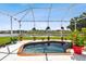 Inviting screened-in pool with brick coping and lake view at 5056 Lakehurst Ct, Palmetto, FL 34221