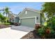 Attached garage with a light-green door and a stone accent at 5056 Lakehurst Ct, Palmetto, FL 34221