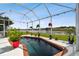 Inviting screened-in pool with brick coping and lake view at 5056 Lakehurst Ct, Palmetto, FL 34221