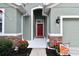 Inviting front entry with a red door and stone accents at 5056 Lakehurst Ct, Palmetto, FL 34221