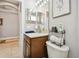 Clean bathroom with wood vanity, toilet, and decorative accents at 5056 Lakehurst Ct, Palmetto, FL 34221