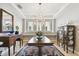 Elegant dining room with a chandelier and large windows at 5056 Lakehurst Ct, Palmetto, FL 34221