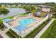 Community pool with a clubhouse and lush landscaping at 5056 Lakehurst Ct, Palmetto, FL 34221