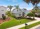 Green house with palm trees and landscaped yard at 5056 Lakehurst Ct, Palmetto, FL 34221
