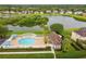 Aerial view of community pool and lakefront property at 5056 Lakehurst Ct, Palmetto, FL 34221