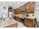 Kitchen with wood cabinets, granite counters, and stainless steel appliances at 5056 Lakehurst Ct, Palmetto, FL 34221