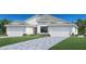 Two-story home with a three-car garage and landscaped lawn at 18848 Dayspring Pl, Venice, FL 34293