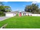 One-story home with a red door and lush green lawn at 772 Nantucket Rd, Venice, FL 34293