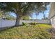 Large backyard with established trees, garden boxes, and privacy fence at 772 Nantucket Rd, Venice, FL 34293