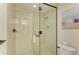 Large walk-in shower with glass enclosure and neutral tile at 391 Aruba Cir # 302, Bradenton, FL 34209