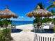 Relaxing beachfront seating with thatched umbrellas at 391 Aruba Cir # 302, Bradenton, FL 34209