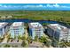 Aerial view of waterfront community with 3-story buildings, lush landscaping, and parking at 391 Aruba Cir # 302, Bradenton, FL 34209