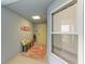 Bright condo entry with bench and surfboard decor at 391 Aruba Cir # 302, Bradenton, FL 34209