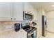 Kitchen detail with stainless steel appliances at 391 Aruba Cir # 302, Bradenton, FL 34209