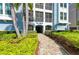 Attractive building entrance with lush landscaping at 391 Aruba Cir # 302, Bradenton, FL 34209