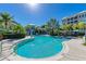 Community pool with lounge chairs and umbrellas at 391 Aruba Cir # 302, Bradenton, FL 34209