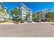 Luxury condo building with parking and tropical landscaping at 391 Aruba Cir # 302, Bradenton, FL 34209