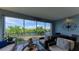 Relaxing lanai with wicker furniture and stunning water views at 391 Aruba Cir # 302, Bradenton, FL 34209