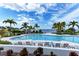 Relaxing pool area with waterfront views and lounge chairs at 391 Aruba Cir # 302, Bradenton, FL 34209