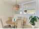 Bright dining room with round table and chairs, features a stylish light fixture at 391 Aruba Cir # 302, Bradenton, FL 34209