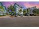 Luxury condo building with parking and tropical landscaping at 391 Aruba Cir # 302, Bradenton, FL 34209
