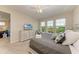 King bedroom with TV, dresser, and calming water views at 391 Aruba Cir # 302, Bradenton, FL 34209