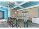 Outdoor pool bar with seating and tropical decor at 391 Aruba Cir # 302, Bradenton, FL 34209