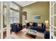 Comfortable sitting room with a navy blue sofa and hardwood floors at 22408 76Th E Ave, Bradenton, FL 34211