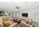 Open living area with neutral decor and large TV at 5852 Elegant Orchid Way, Sarasota, FL 34232