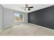 Well-lit bedroom with neutral walls and carpet flooring at 5852 Elegant Orchid Way, Sarasota, FL 34232