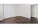 Bedroom with dark wood floors and closet at 7022 Chatum Light Run, Bradenton, FL 34212
