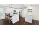 Modern kitchen with white cabinets, granite countertops, and stainless steel appliances at 7022 Chatum Light Run, Bradenton, FL 34212